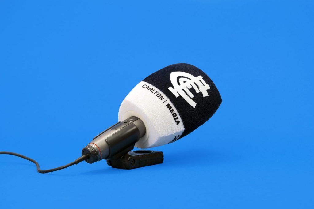Carlton Media branded microphone windshield with black and white color block design, professional broadcast windscreen with custom logo