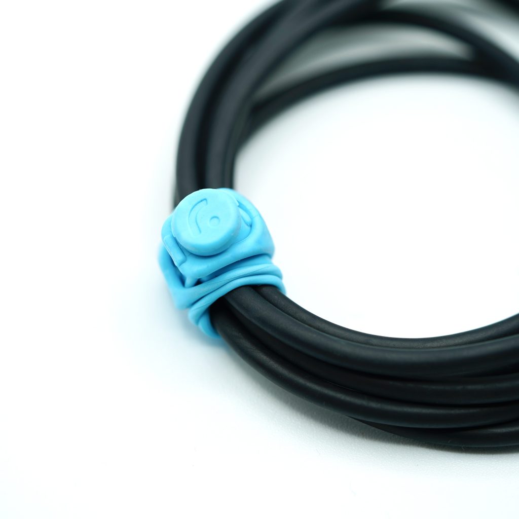 RAD cable strap securing black audio cable with locking mechanism engaged