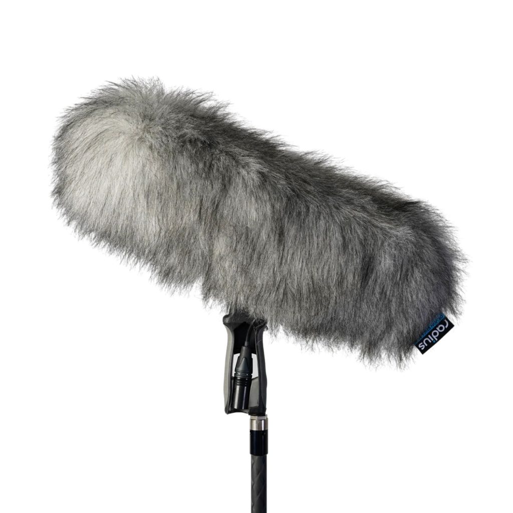 Grey windcover displayed with Rycote windshield system for size reference